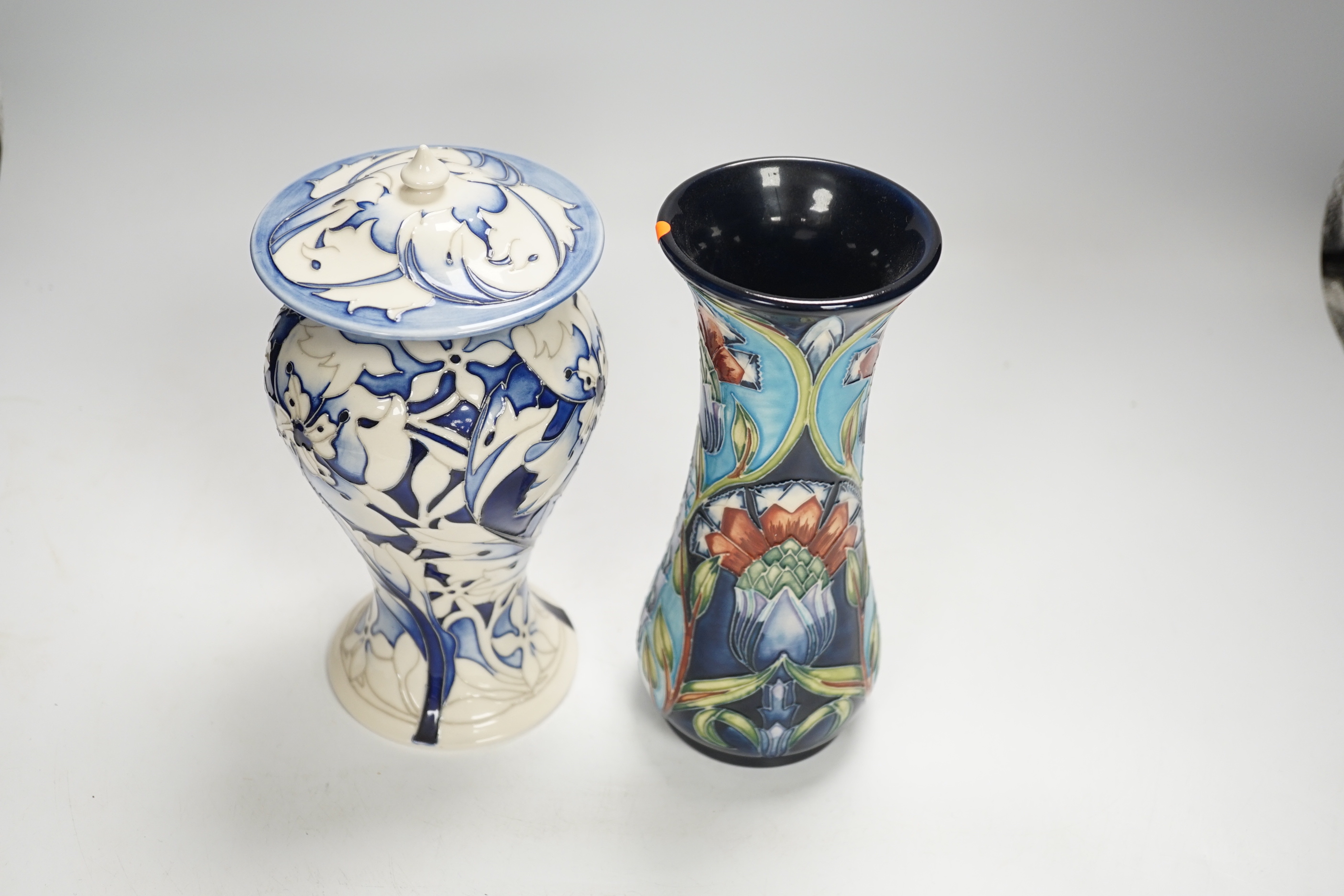 A Moorcroft floral vase designed by Shirley Hayes, limited edition 27/30 and a Moorcroft blue and white jar and cover by Emma Bossons, limited edition 2/3, largest 23cm high